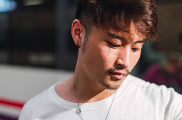 istock Young asian man using smartphone and smart watch in train 1330277858