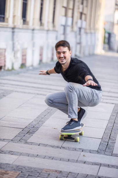istock A Young Man is Enjoying Vacation While Riding a Skateboard in the City and Exploring. 1330278951