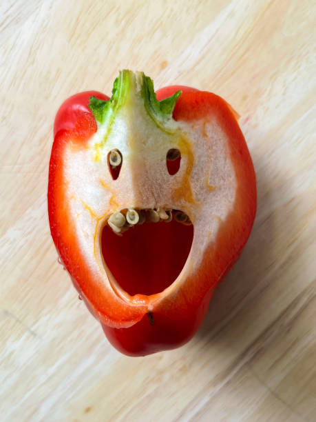 Sliced bell pepper on wooden cutting board seen from above