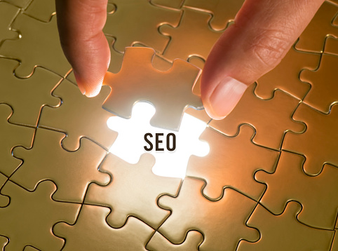 Hand holding a puzzle piece with “Seo” text underneath