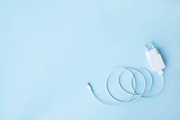 istock Mobile charger and USB Cable on blue background. Top view. Copy, empty space for text 1330281378