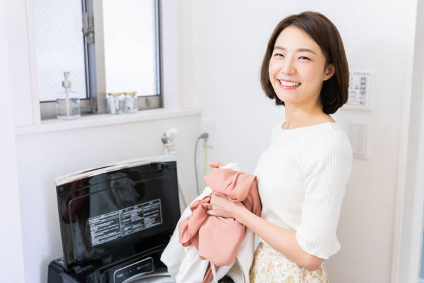 istock attractive asian woman doing the laundry 1330294193