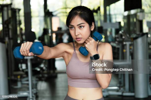 An Asian Women Exercise With Dumbbells For Boxing In Fitness Gym With A Boxing Dumbbell Workout Boxers Will Develop The Muscles In Arms Self Care And Lose Weight Concept Stock Photo - Download Image Now