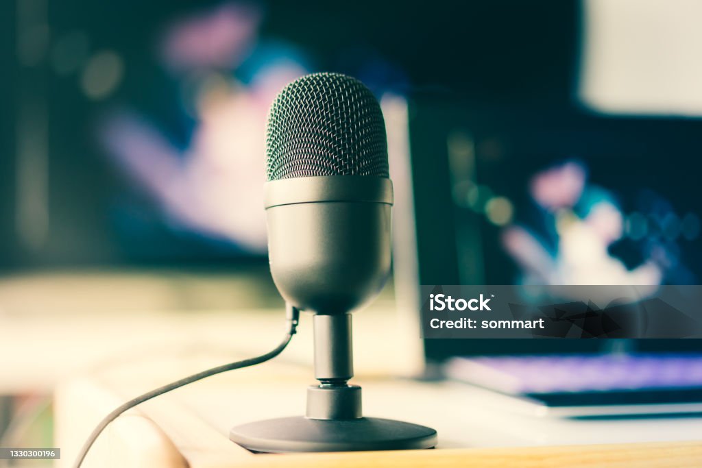 Microphone with laptop live video and working at home concept Podcasting Stock Photo