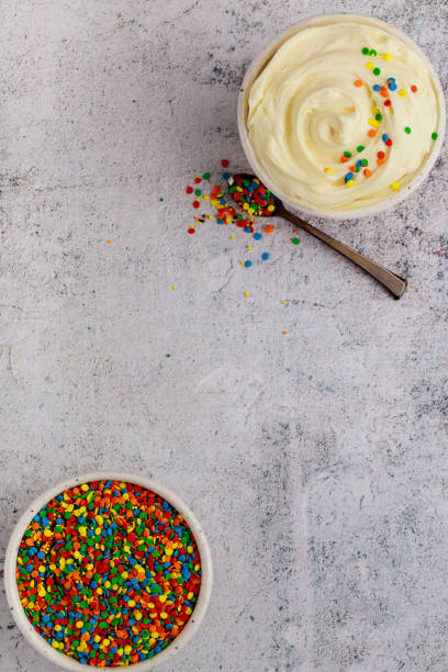 istock Butter cream and sprinkles in bowls with spoon. 1330306366