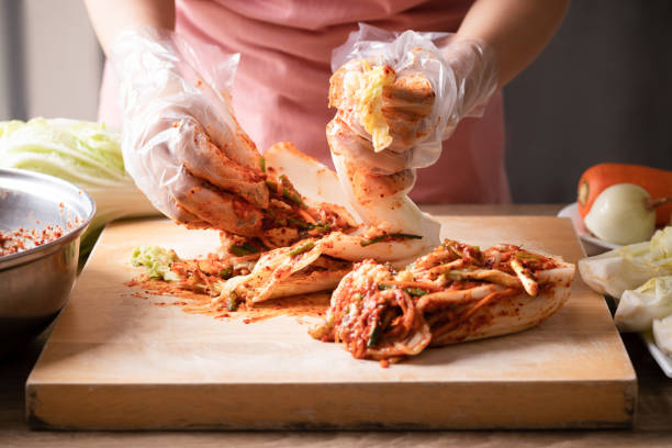 Korean food, Woman making kimchi cabbage stock photo