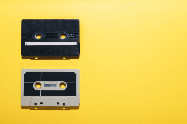 istock Two cassette tapes isolated on a yellow background 1330315331