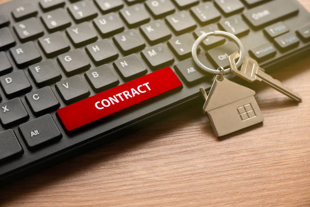 istock Property and real estate concept. House key with computer keyboard with red button written with CONTRACT. 1330319019