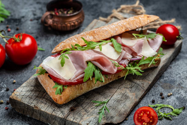 istock Turkey sandwich with ham, tomato, parmesan and arugula. appetizer bruschetta 1330319625