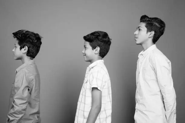 Photo of Three young Indian brothers together in black and white