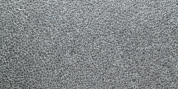 Black grain background. Gray wall for board background. Grey styrofoam foam texture or white plastic polystyrene pattern
