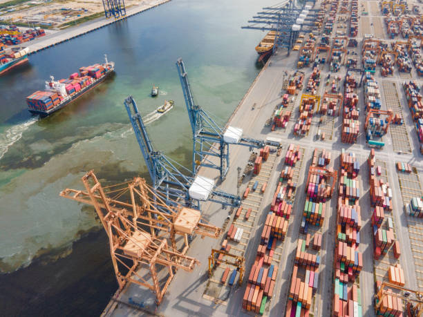 istock Container demand growth theme Drone aerial around logistics business growth e-commerce import export and transportation working crane bridge in shipyard shipping 2021 1330324030
