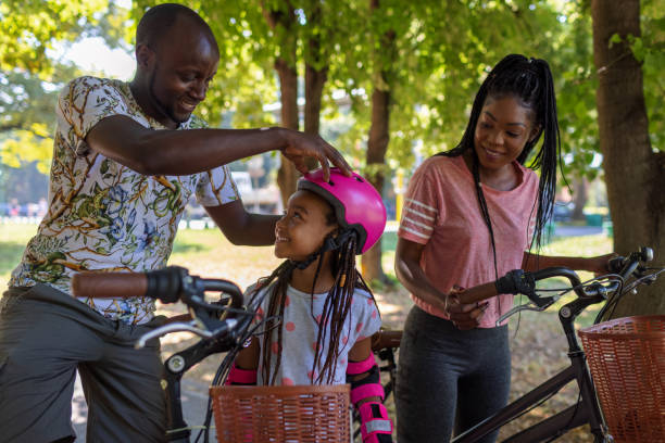 istock Father Adjusting Helmet To His Little Daughter 1330325219