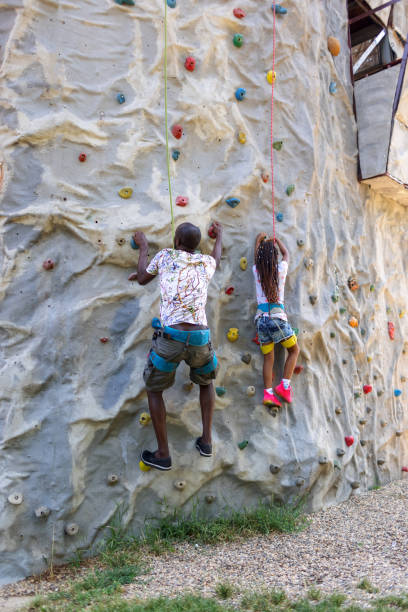 Boy climbing up on climbing wall.