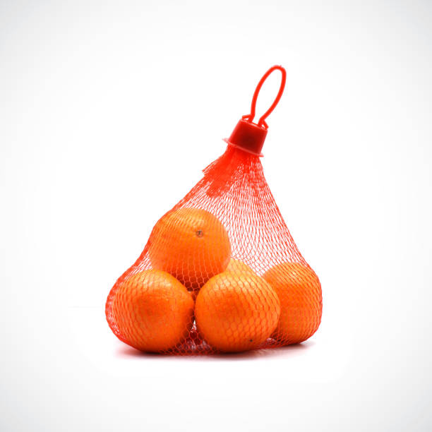 istock Fresh oranges inside a mesh bag are available for sale. 1330329448