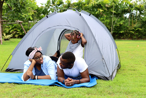Happiness Africa young family camping at garden park in home.