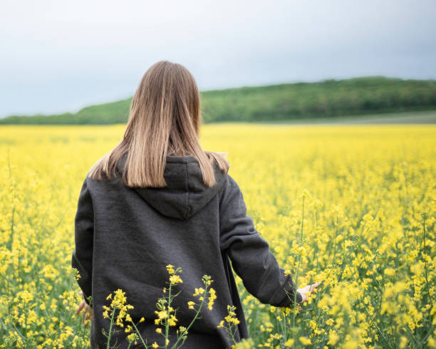 istock Young girl on yellow rapeseed field 1330337884