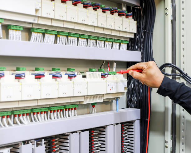 istock An electrical engineer is investigating an electrical control cabinet maintenance concept. 1330338180