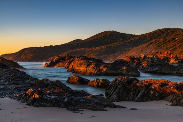 istock Sunrise seascape and a rocky beach 1330344983