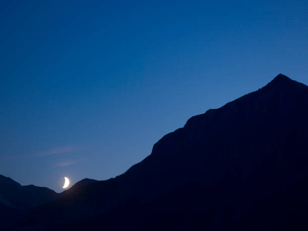istock Moon rises above mountain pass, at twilight 133034524