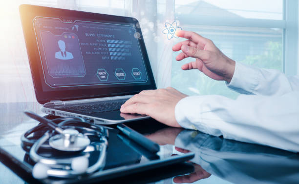 the doctor working on a laptop computer for health records in the medical office.the concept is checking and taking care of patients' health online. - medical exam doctor patient adult imagens e fotografias de stock