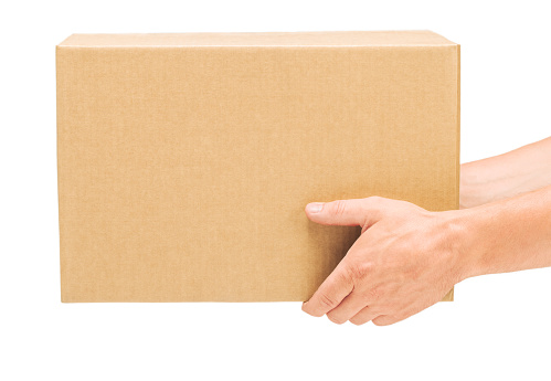 Corrugated cardboard box in male hands on an isolated white background, no people, part of the body