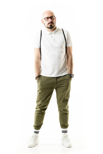 istock Bald nerdy stylish geek man with glasses posing with hands in pockets. 1330350778