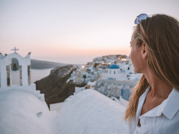istock Woman contemplates Santorini from top, Greece 1330351241