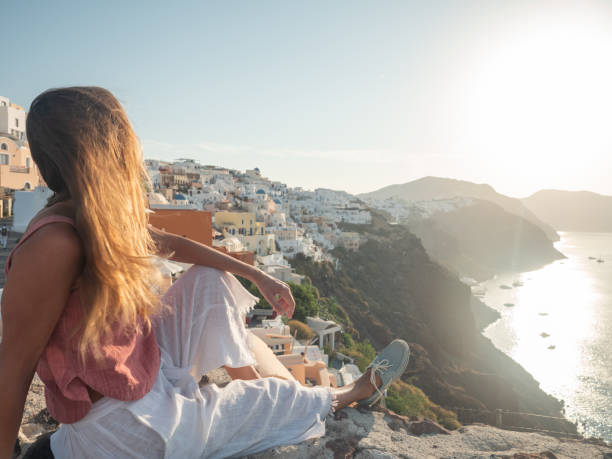 istock Woman contemplates Santorini from top, Greece 1330351898