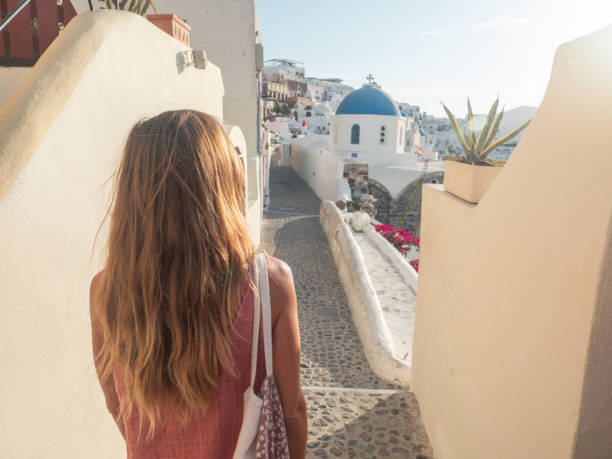 istock Woman contemplates Santorini from top, Greece 1330351914