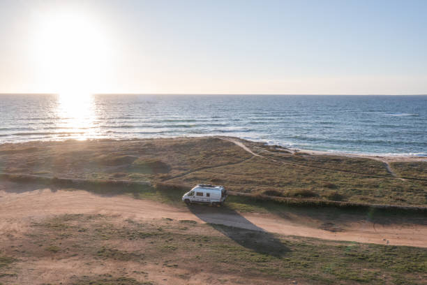 istock Drone view of coastline, van parked on unpaved road 1330354237