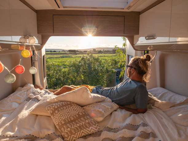 istock Man looks at sunset from his van 1330354602