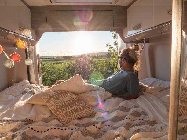 istock Man looks at sunset from his van 1330354604