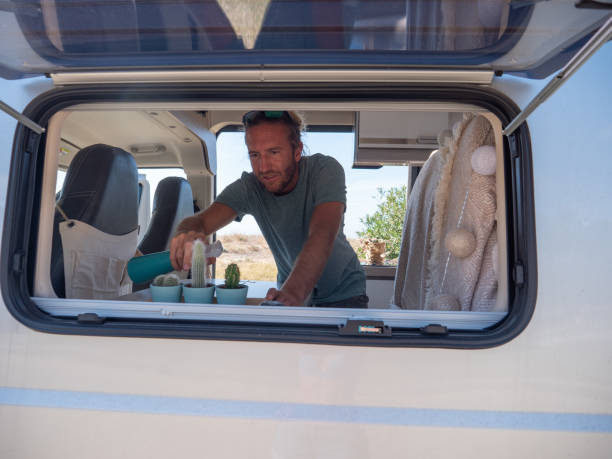 istock Man looks after cactuses in his van 1330354630