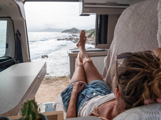 istock Woman in her van looking at ocean 1330354756