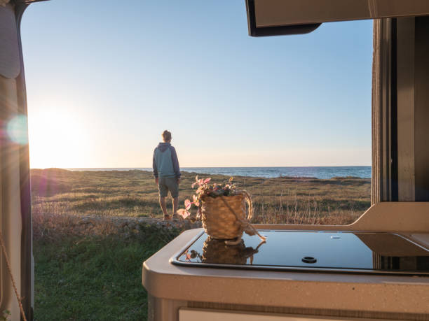 istock Man contemplates the sea, van view 1330354802