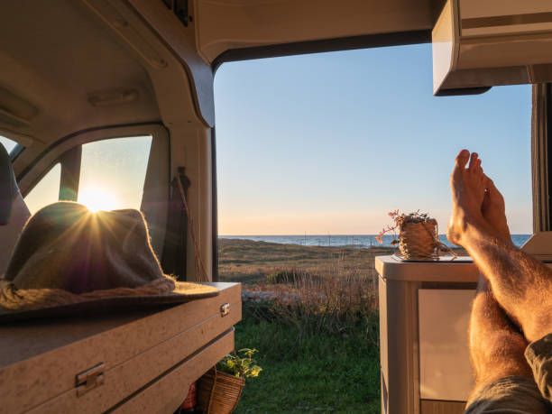 istock Man lying in a van looking at the ocean, POV 1330354807
