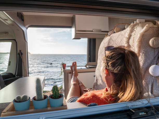 istock Woman in her van looking at ocean 1330354865
