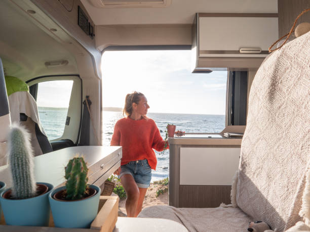 istock Woman in her van looking at ocean 1330354876