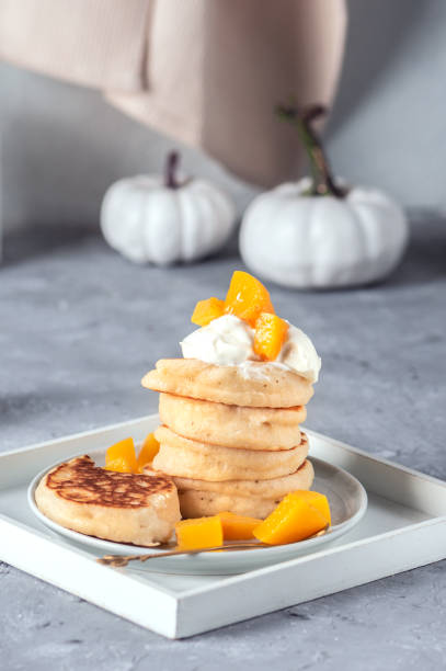 istock Small pancakes with yoghurt and peaches 1330355761