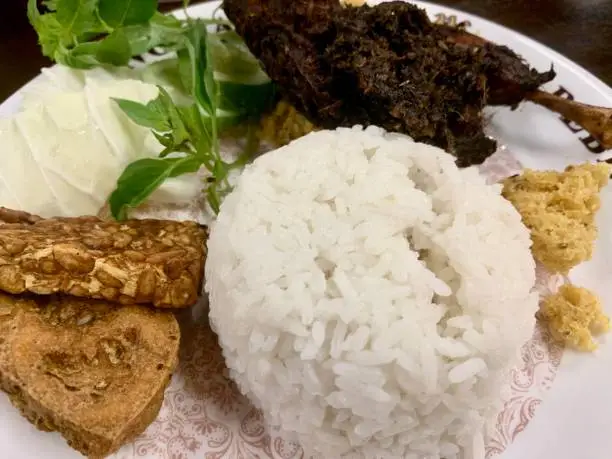 Photo of Fried duck, tofu and tempeh with white rice for dinner