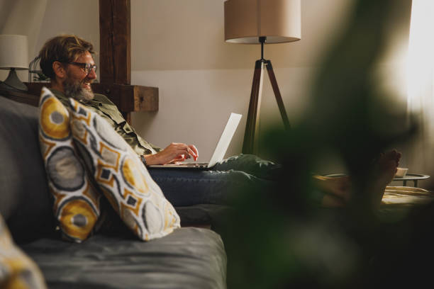 istock Cheerful mature man hearing from his friends online 1330359090
