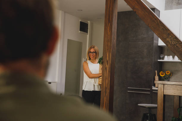 istock Woman calling her husband to help her put away the groceries 1330360032
