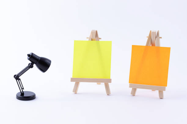 istock Two Wooden Easels Miniature with Blank Colored Square Canvas or Memo Paper 1330361396