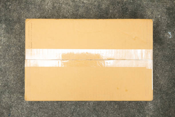 Sticky transparent tape on a cardboard box. Top view