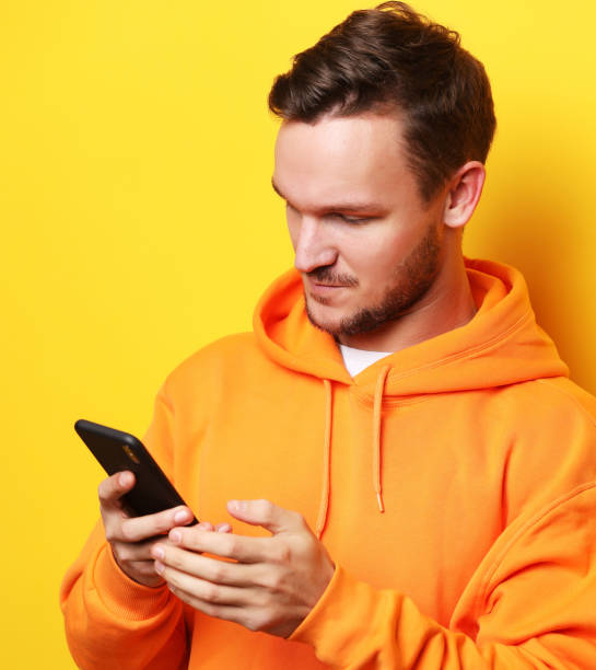 istock young man holding mobile phone and making photo 1330367238