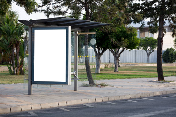 istock Vertical blank billboard on the city street with green trees 1330367324