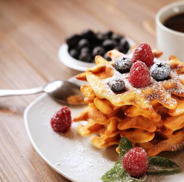 istock Waffles with berries on a white plate and coffee, close up 1330368238