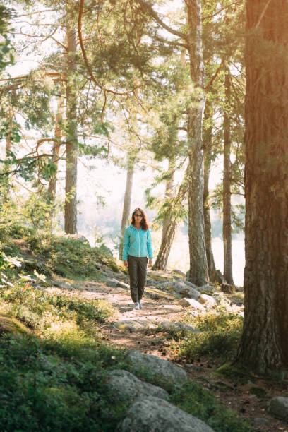 istock Woman walking in the pine forest. 1330374040