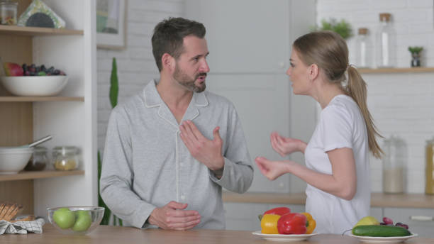 istock Young Woman Arguing with Man in Kitchen 1330374212